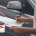 Car ownership transfer in Dubai at an RTA center with prepared documents